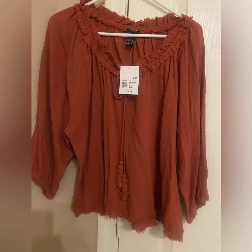 Brand new Top with tassels on the tie in a Rust color cotton round neck